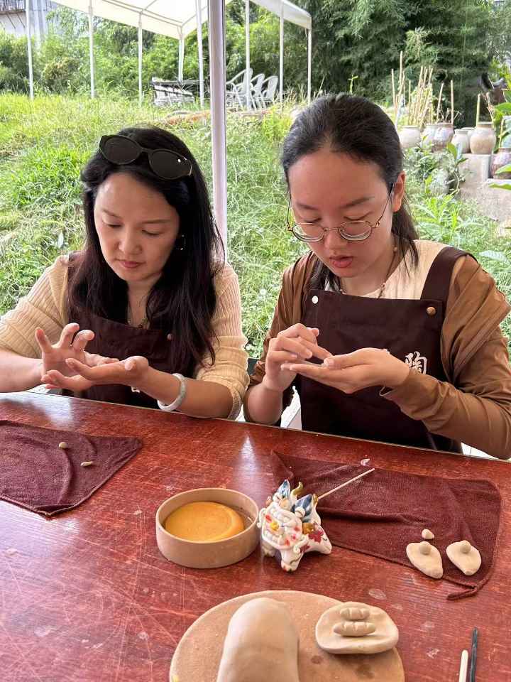 两人一起揉捏瓦猫的泥坯